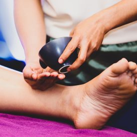 foot and leg massage, Therapist pouring oil to a foot about to massage