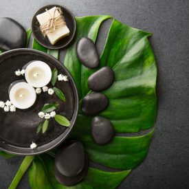 Spa accessories on dark background Spa Wellness Relax concept. Spa background with spa accessories on dark background. View from above with copy space.